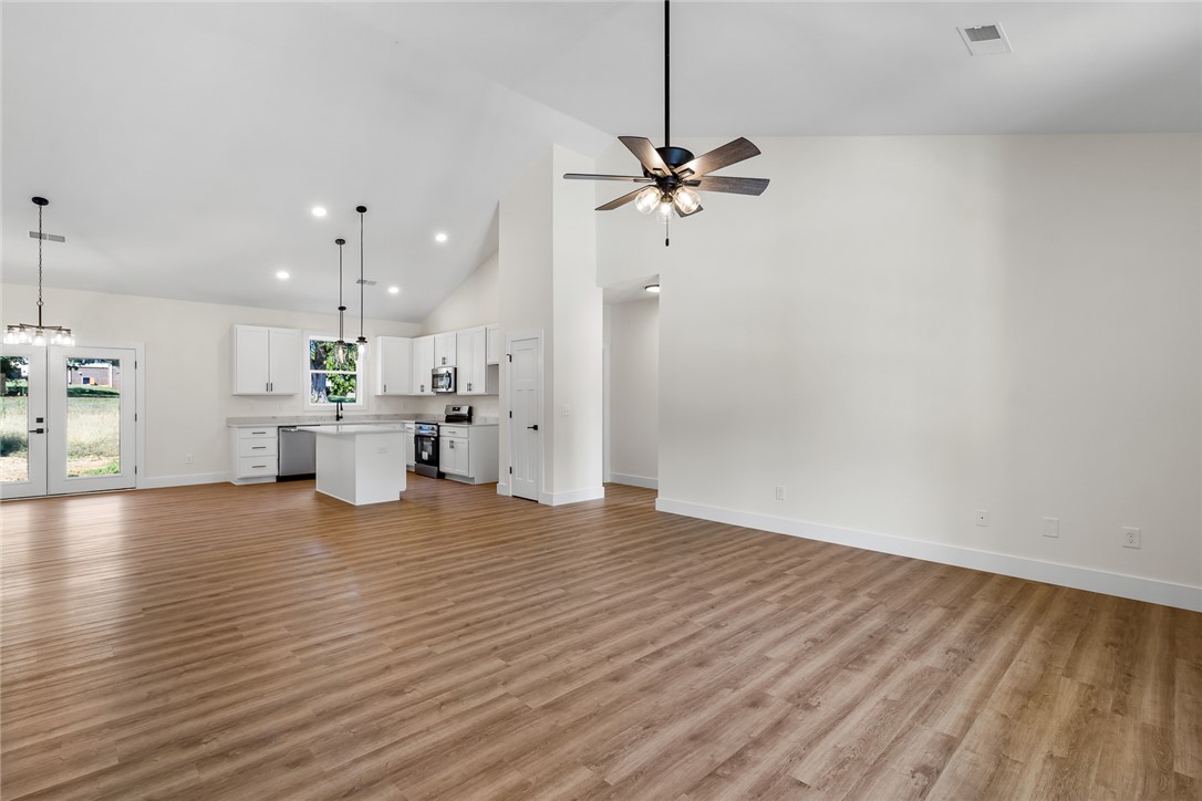 1507 Tindall Avenue Anderson, SC 29621 - Photo 6 of 38 Soaring vaulted ceilings and warm wood floors define this light-filled, open-concept living space.