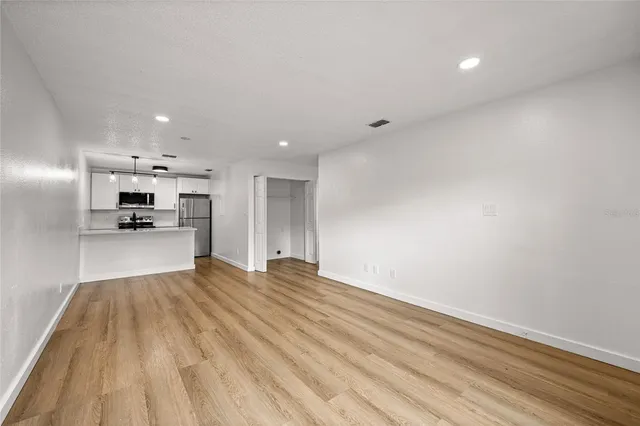 a view of kitchen with refrigerator microwave and stove