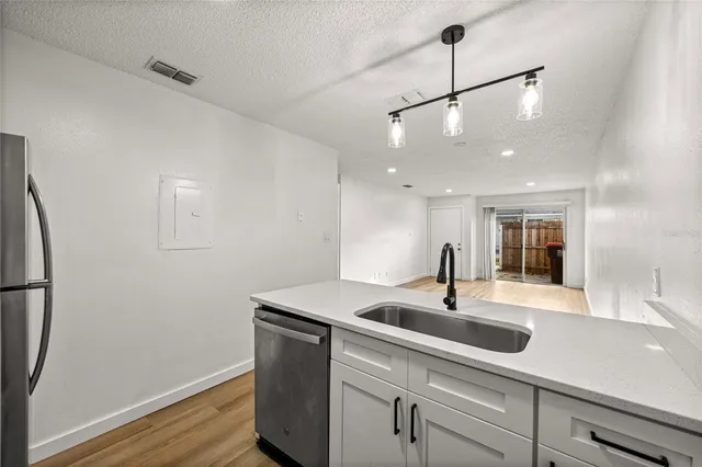 a kitchen with a sink and chandelier