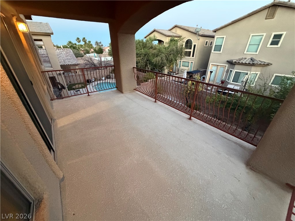 7629 Rory Court Las Vegas, NV 89129 - Photo 10 of 25 A spacious private balcony offers captivating views of the neighborhood pool.