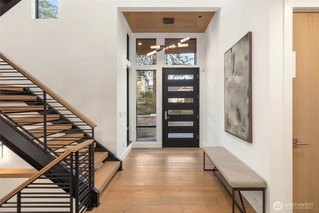 a living room with furniture and a floor to ceiling window
