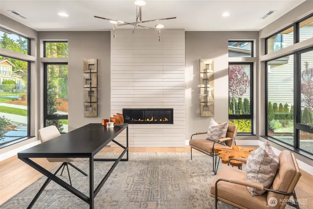 a living room with fireplace furniture and a large window