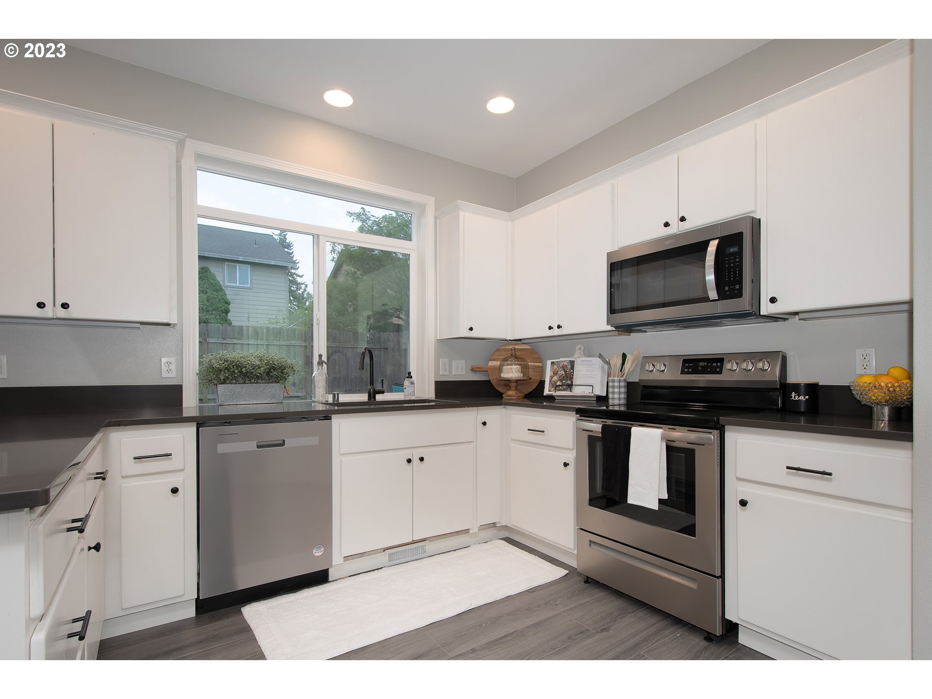 1830 North 8th Way Ridgefield, WA 98642 - Photo 11 of 44 a kitchen with stainless steel appliances granite countertop a stove a sink and a microwave