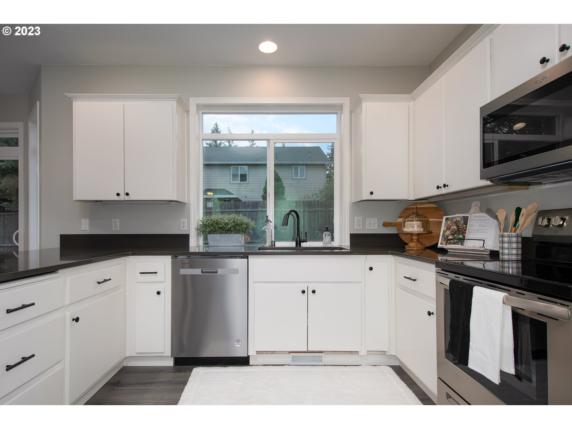 1830 North 8th Way Ridgefield, WA 98642 - Photo 12 of 44 a kitchen with stainless steel appliances kitchen island granite countertop a sink and cabinets