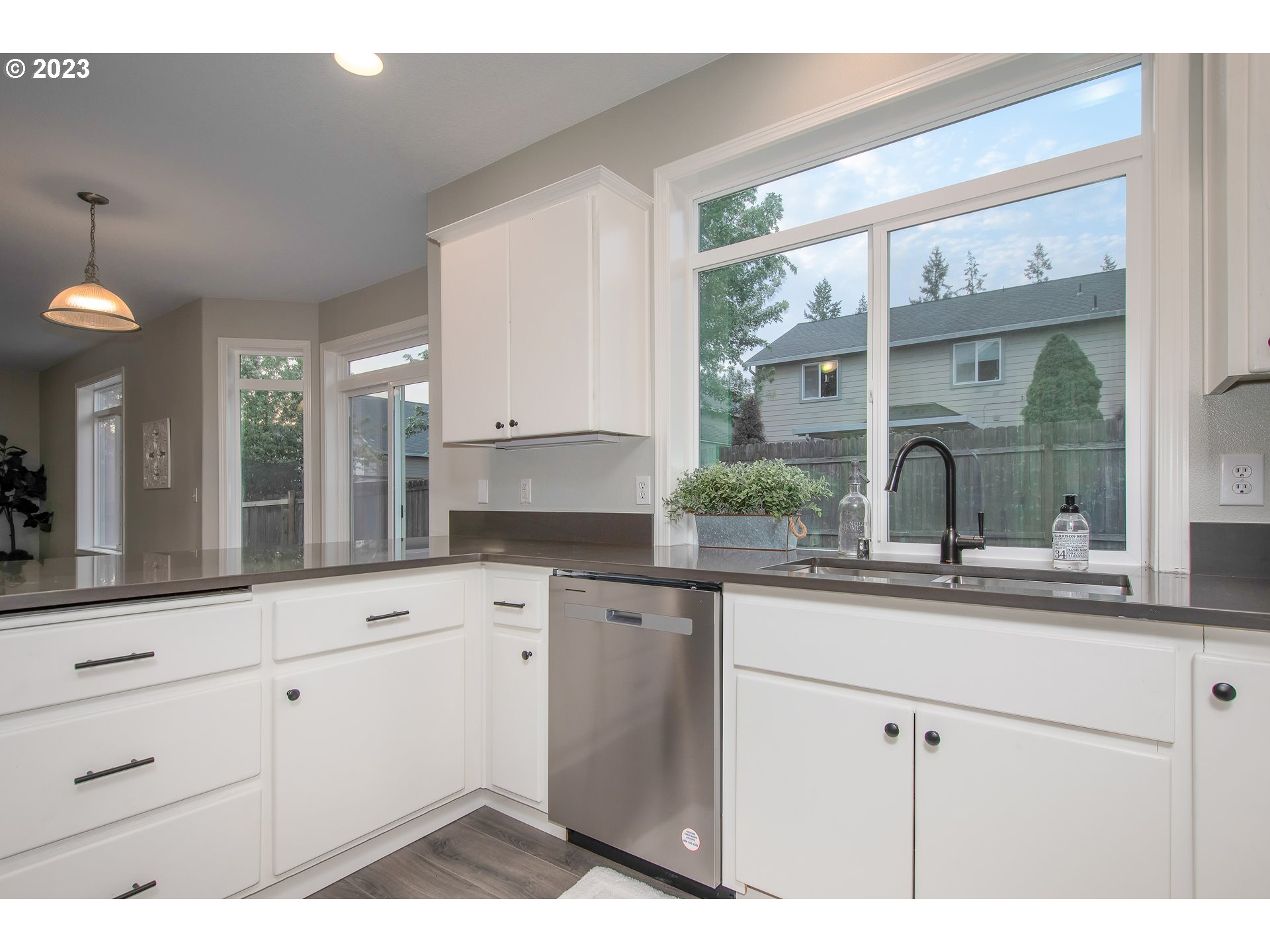1830 North 8th Way Ridgefield, WA 98642 - Photo 13 of 44 a kitchen with granite countertop white cabinets and a large window