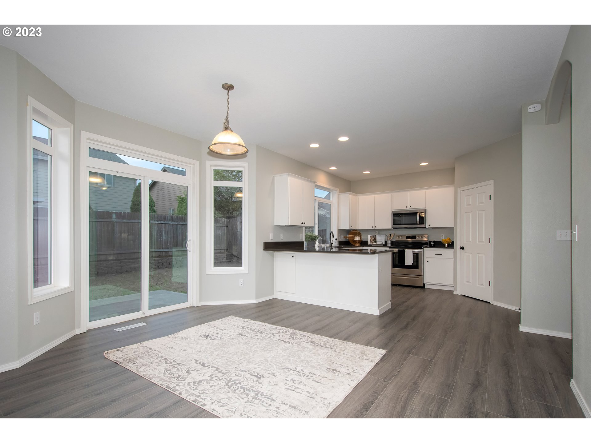 1830 North 8th Way Ridgefield, WA 98642 - Photo 15 of 44 a kitchen with kitchen island sink and refrigerator