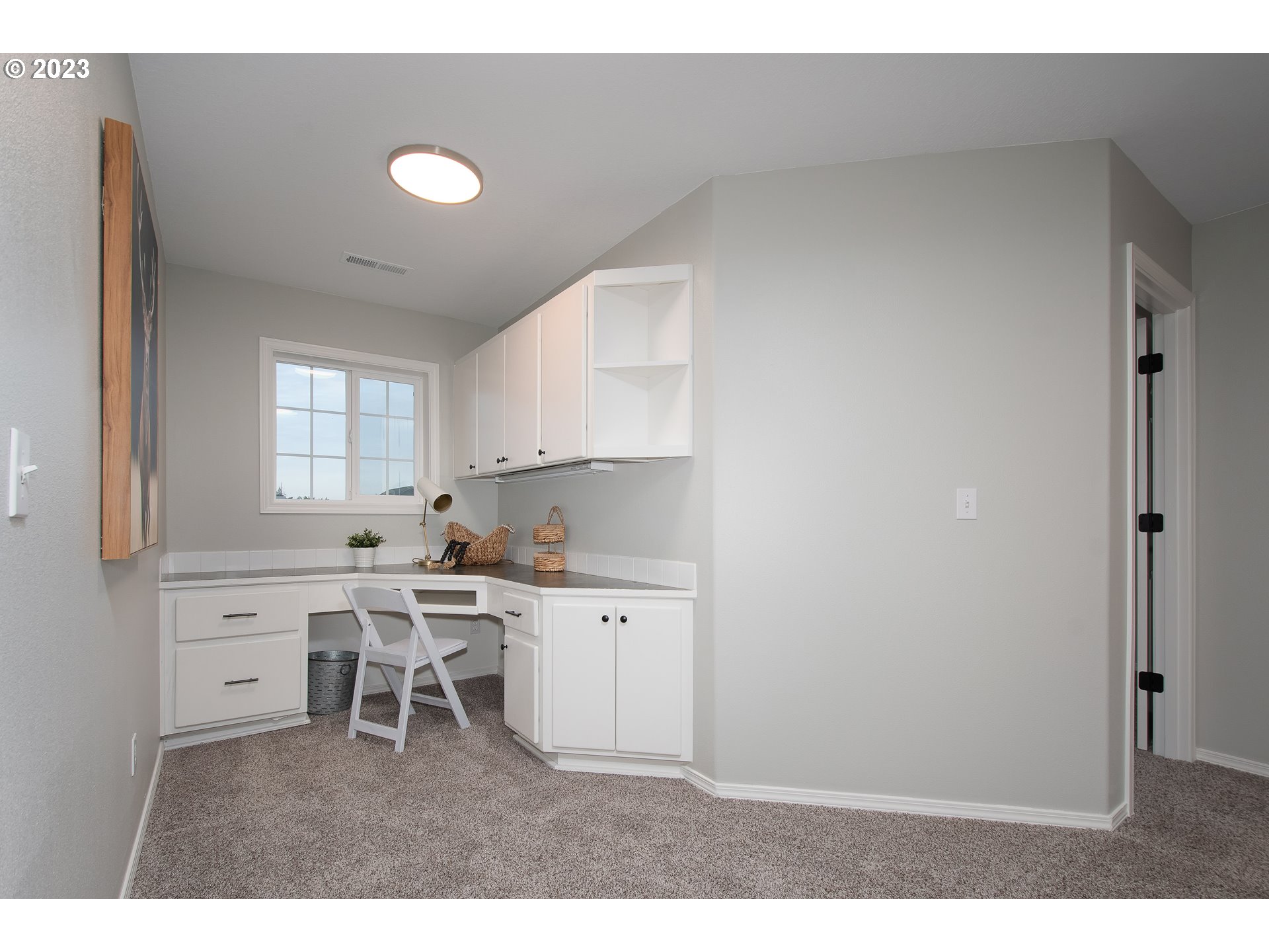 1830 North 8th Way Ridgefield, WA 98642 - Photo 23 of 44 a kitchen with white cabinets and chair