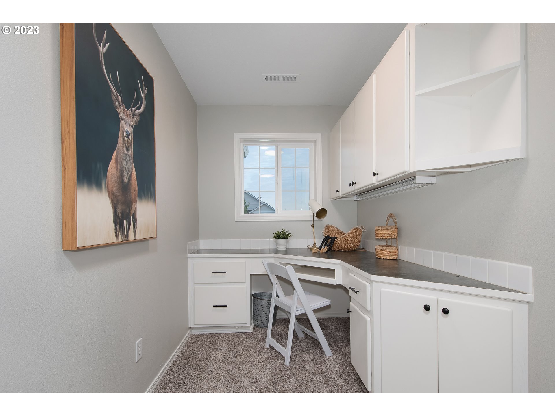 1830 North 8th Way Ridgefield, WA 98642 - Photo 24 of 44 a kitchen with a white cabinets and chairs