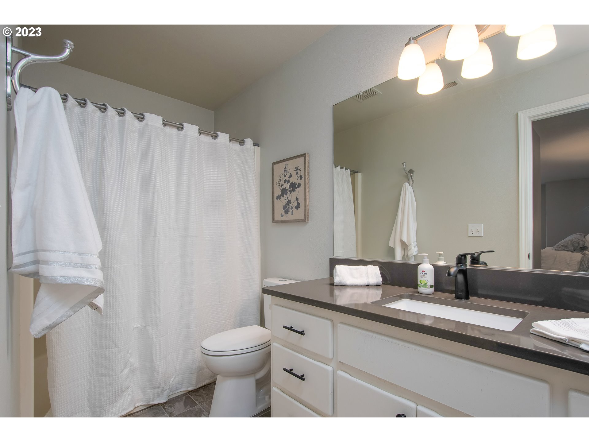 1830 North 8th Way Ridgefield, WA 98642 - Photo 27 of 44 a bathroom with a granite countertop sink a toilet and a mirror