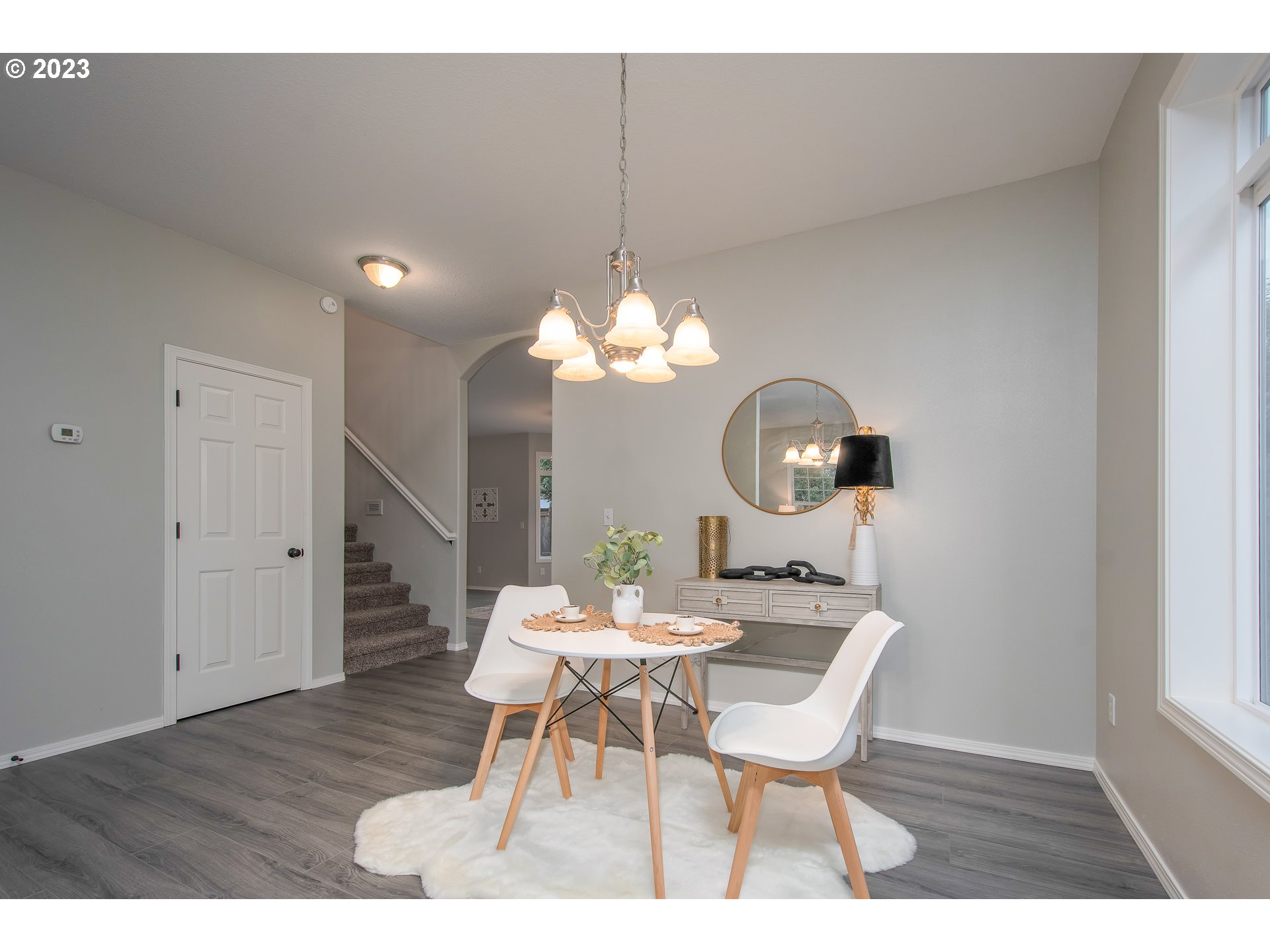 1830 North 8th Way Ridgefield, WA 98642 - Photo 8 of 44 a dining room with furniture a chandelier and wooden floor