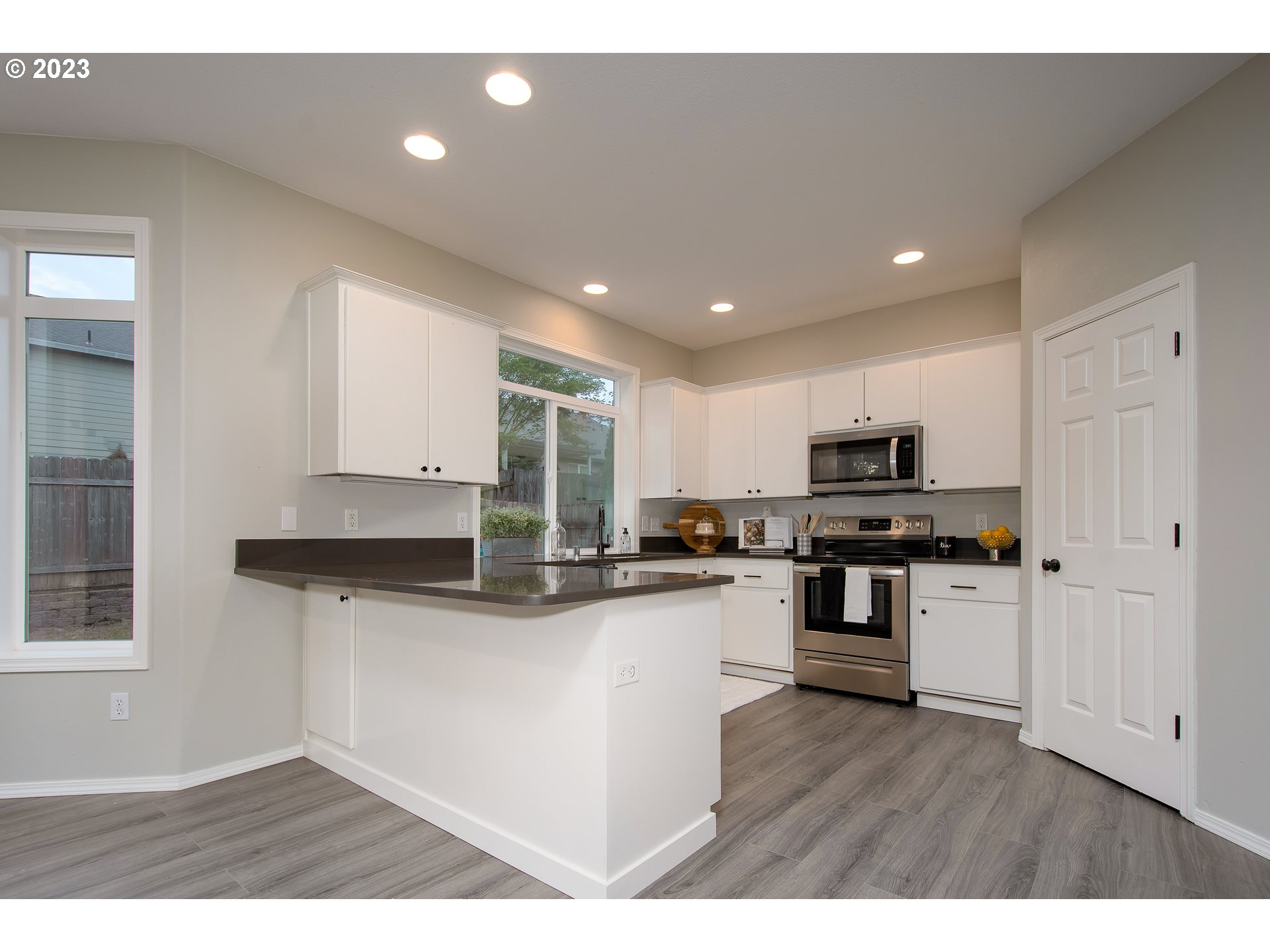 1830 North 8th Way Ridgefield, WA 98642 - Photo 9 of 44 a kitchen with stainless steel appliances granite countertop a stove a sink and a refrigerator