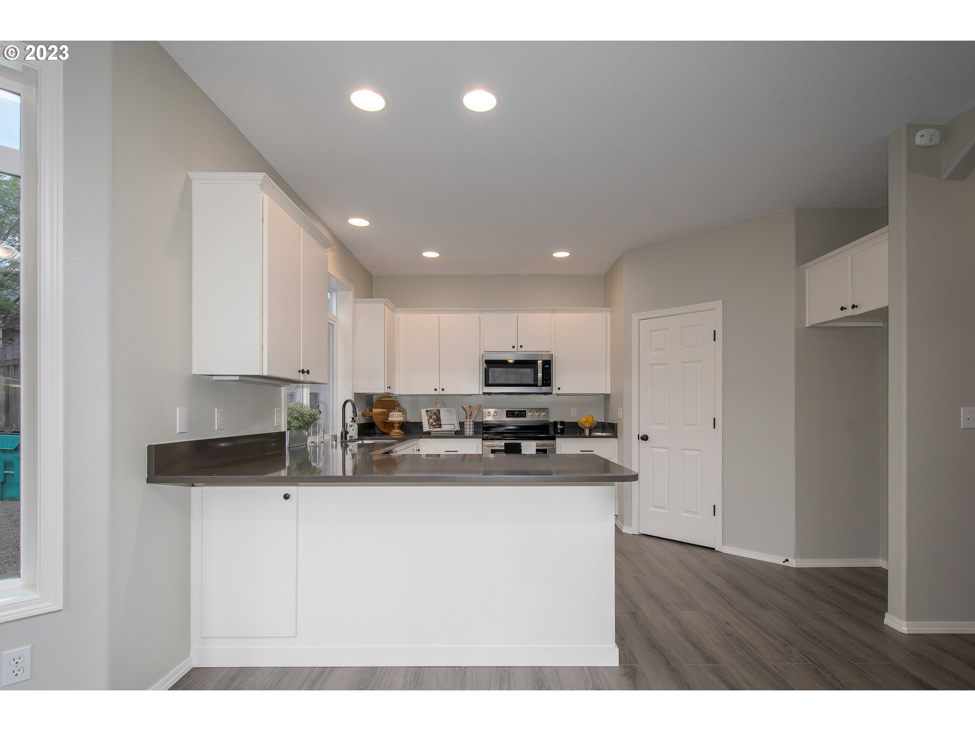 1830 North 8th Way Ridgefield, WA 98642 - Photo 10 of 44 a kitchen with stainless steel appliances granite countertop a sink refrigerator and microwave