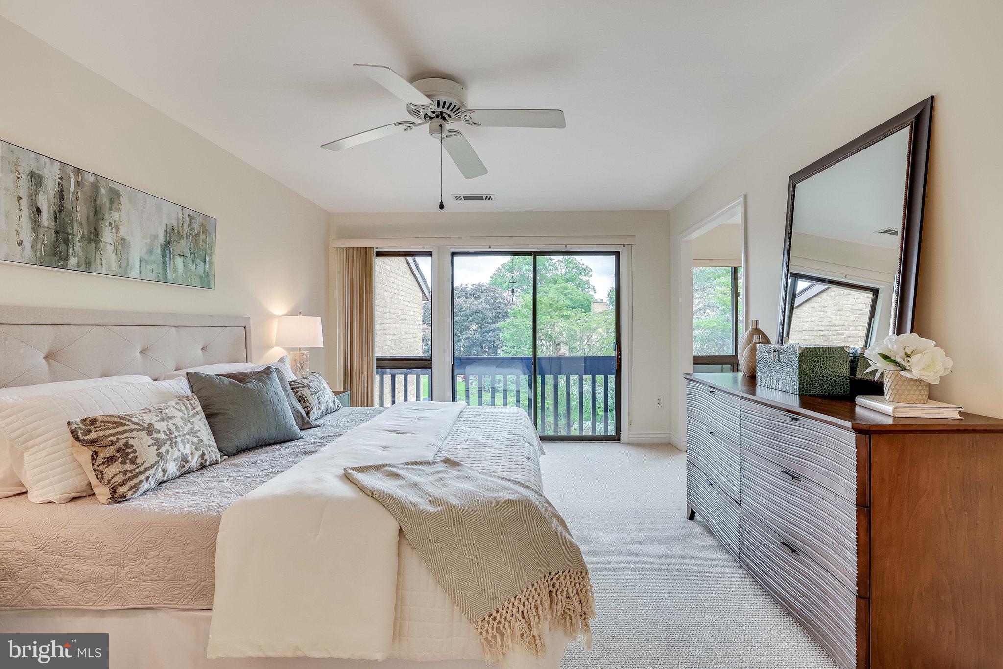 2024 Lakebreeze Way Reston, VA 20191 - Photo 34 of 95 a bedroom with a large bed and a balcony view