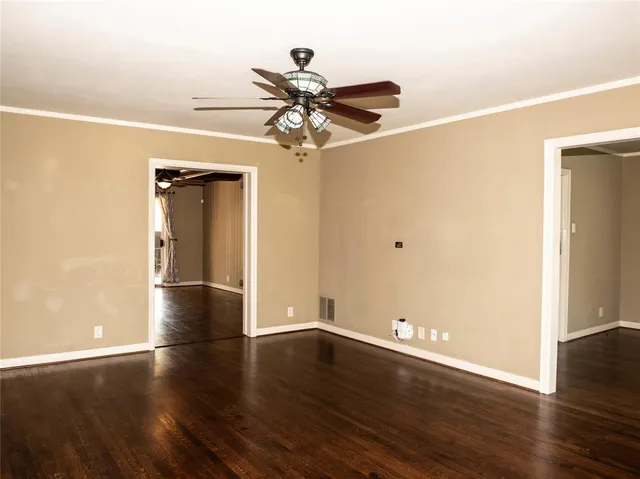 a view of a room with wooden floor