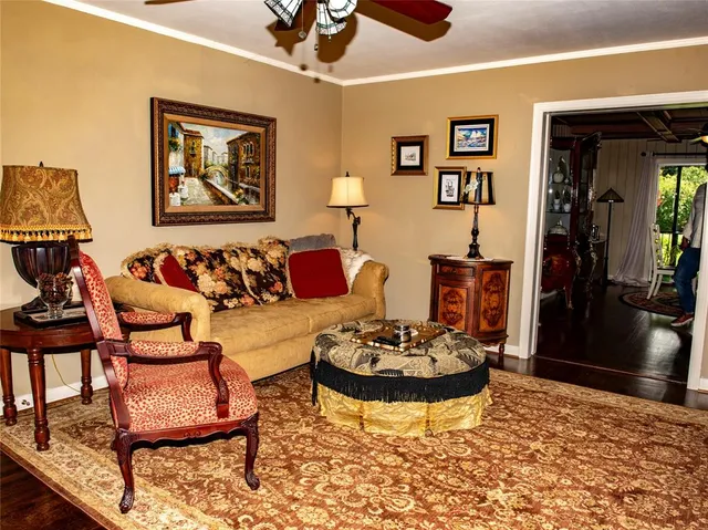 a living room with furniture and painting on the wall