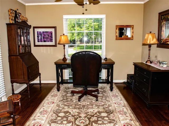 a view of a workspace with furniture and a window