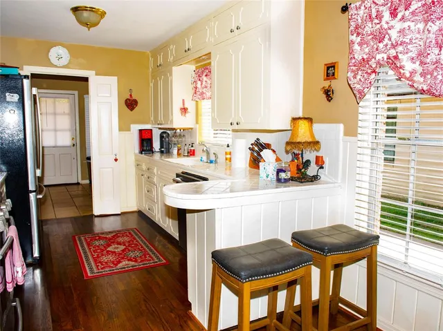 a kitchen with a sink a stove and a refrigerator