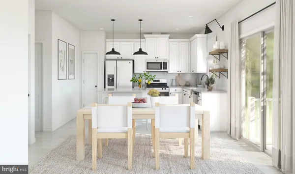 a kitchen with a dining table chairs refrigerator and cabinets