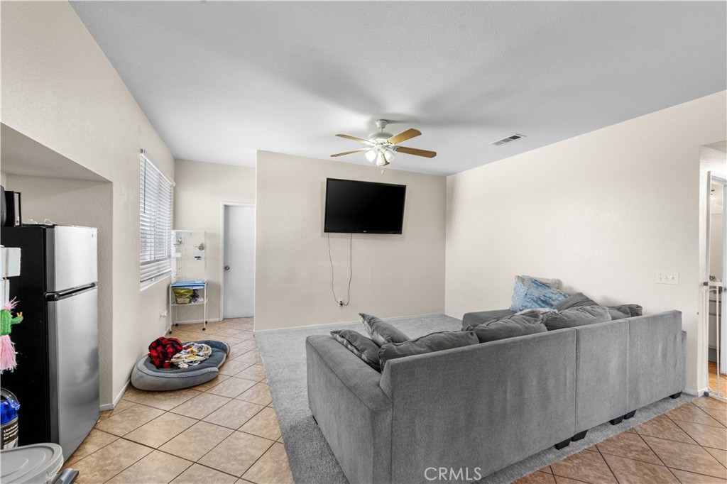 36624 Roosevelt Drive Palmdale, CA 93552 - Photo 10 of 12 a living room with furniture and a flat screen tv