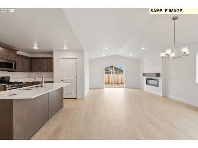 a view of kitchen with sink microwave and stove