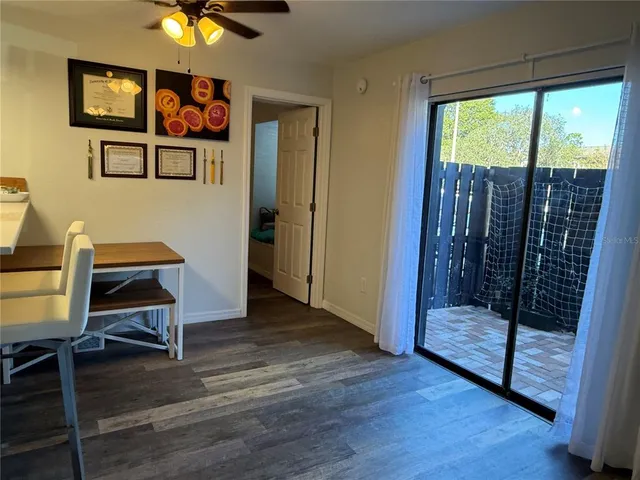 a view of a livingroom with furniture window wooden floor and garden view