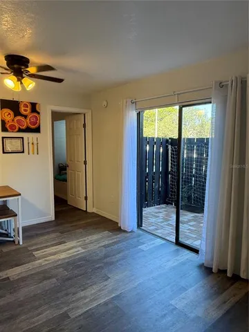 a view of an empty room with glass door and a window