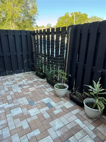 a view of a backyard with wooden fence