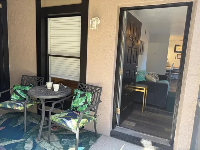 a view of a room with a table and chairs