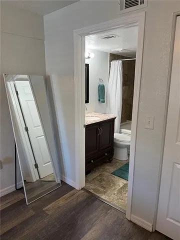 a room with furniture a window and a flat screen tv