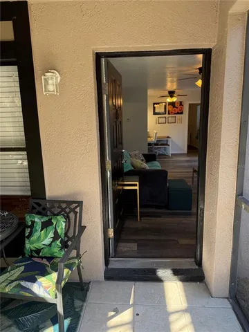 a hallway with dining table and chairs