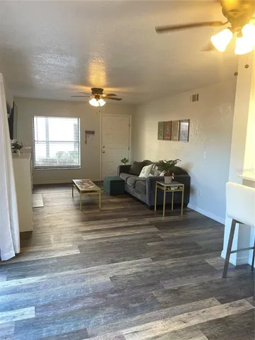 a living room with furniture window and wooden floor