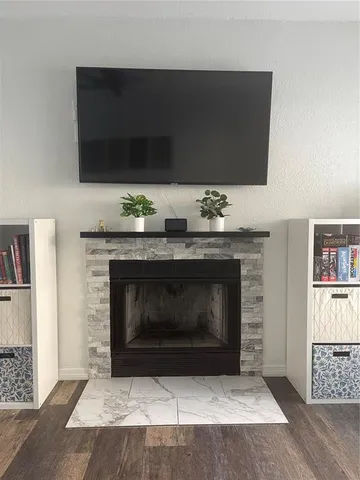 a living room with a fireplace and a flat screen tv