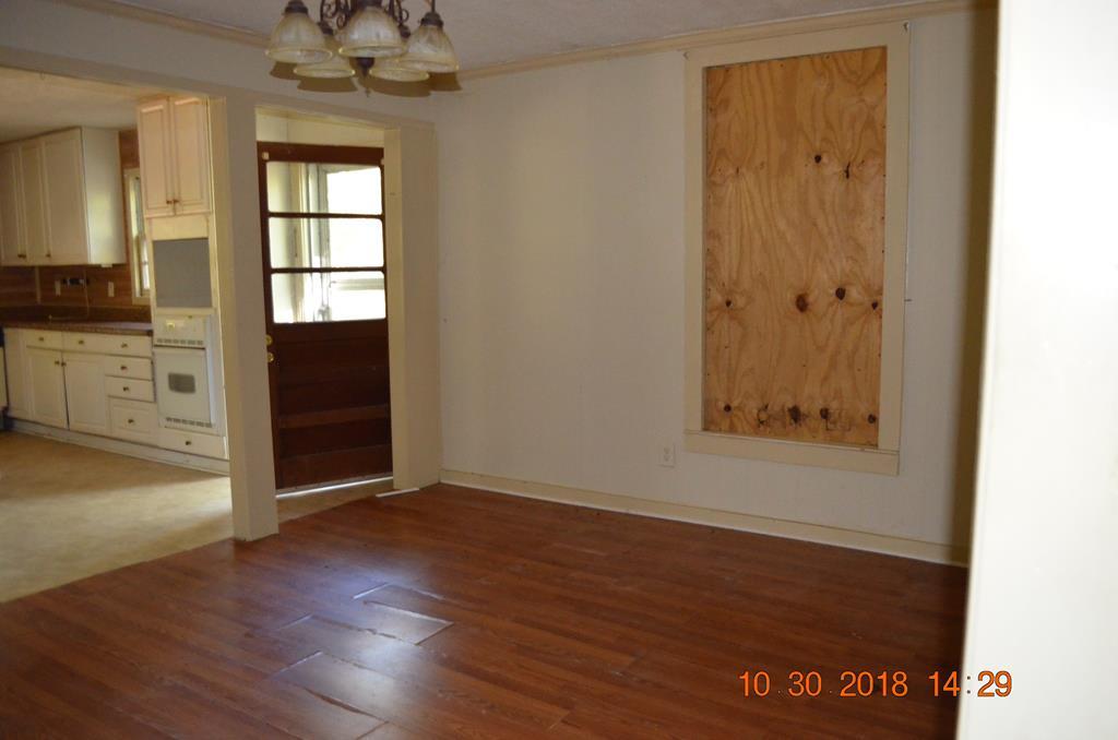 275 Jackson Lindsey Road Forsyth, GA 31029 - Photo 11 of 16 an empty room with wooden floor cabinet and windows