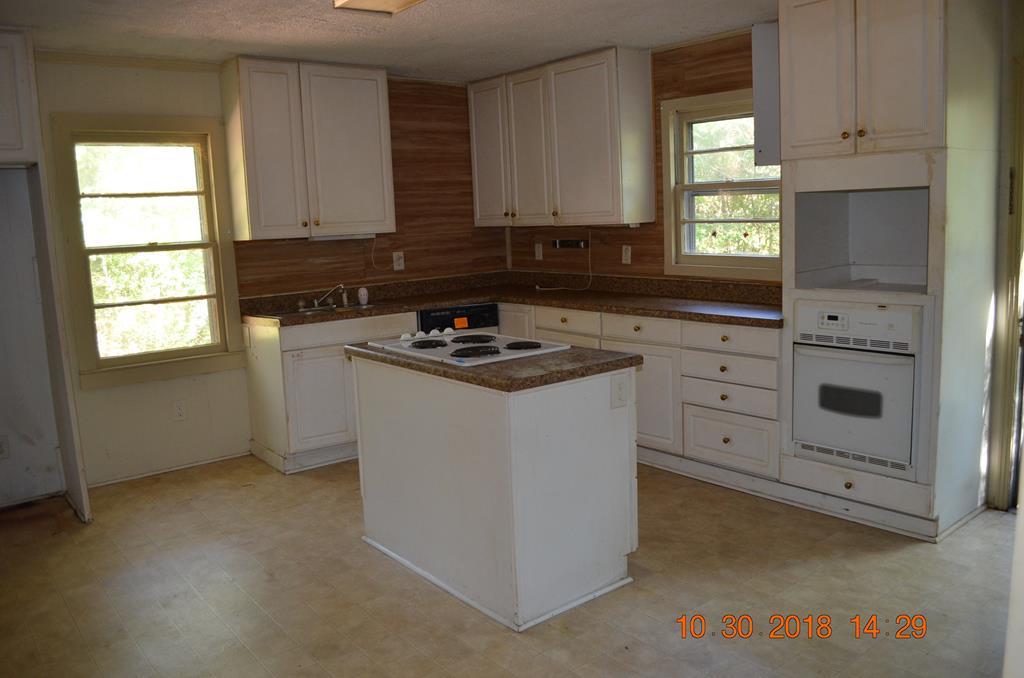 275 Jackson Lindsey Road Forsyth, GA 31029 - Photo 3 of 16 a kitchen with cabinets appliances a sink and a window