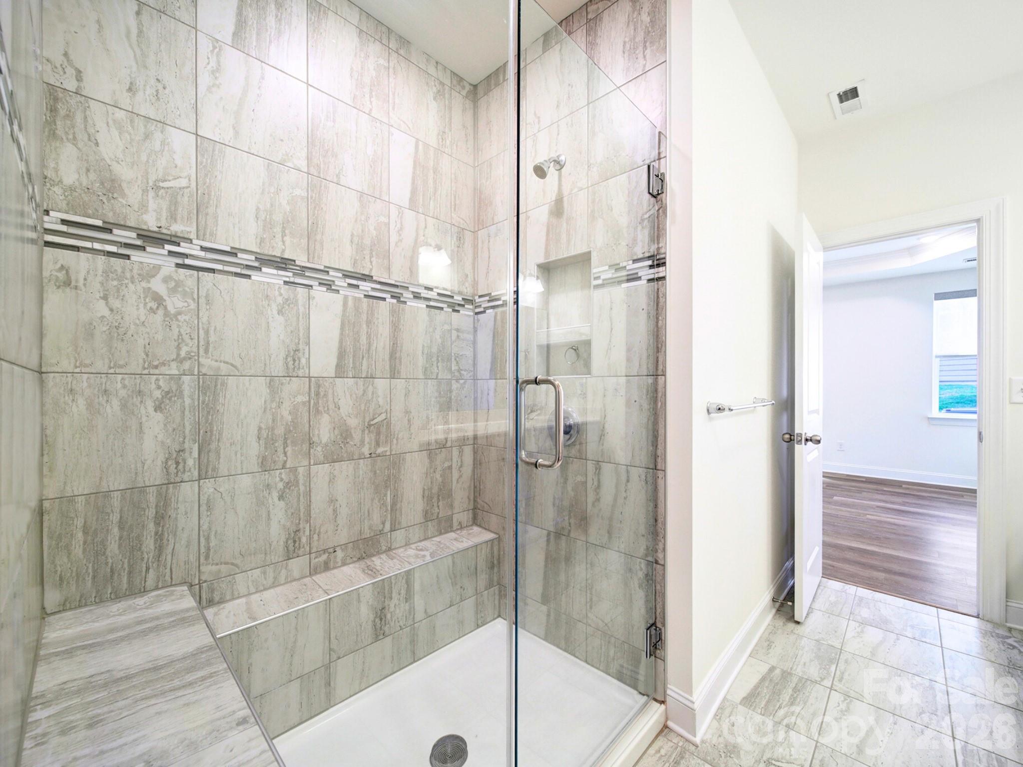 4003 Rothwood Lane Harrisburg, NC 28075 - Photo 14 of 30 a bathroom with a glass shower door