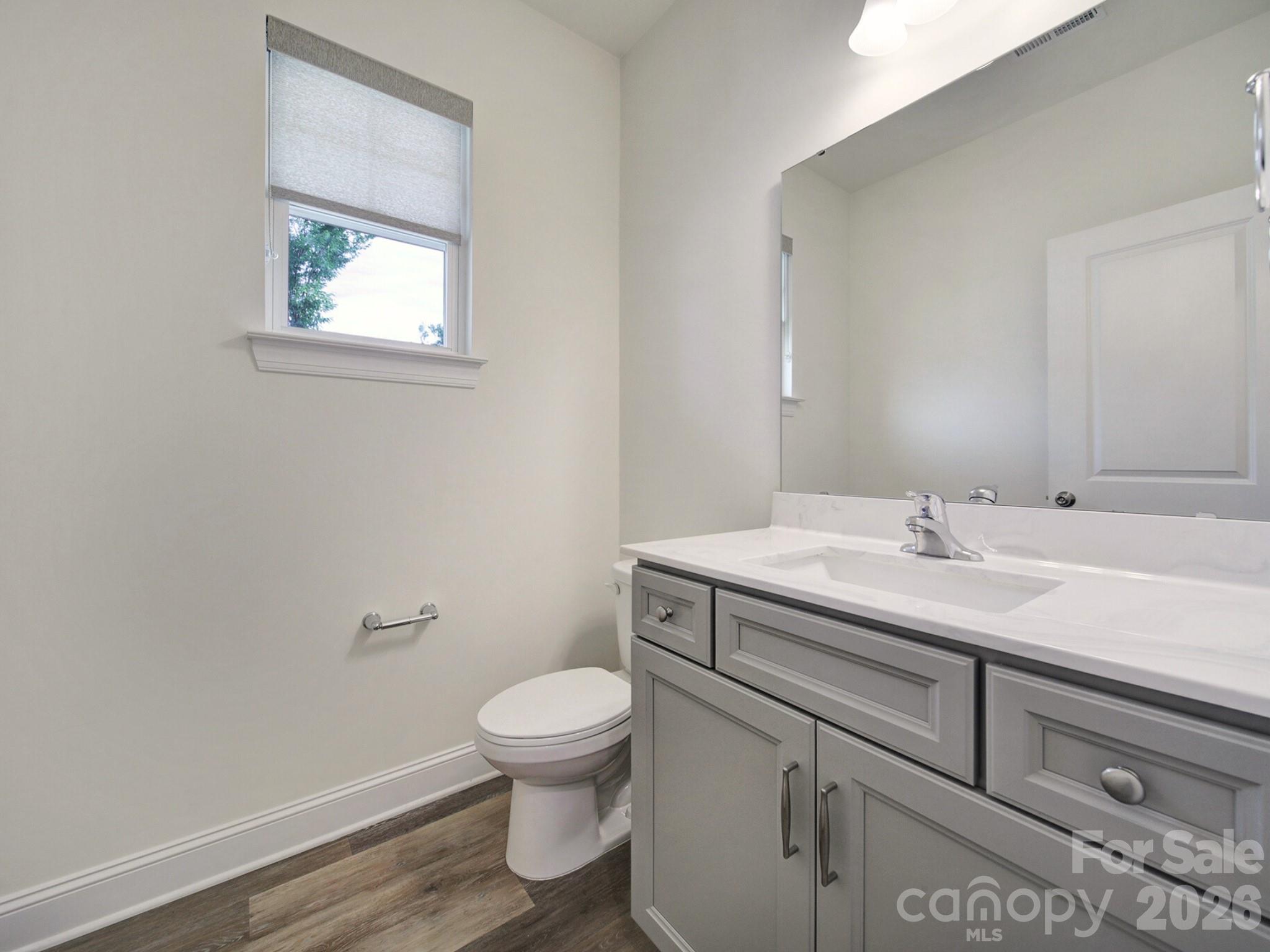 4003 Rothwood Lane Harrisburg, NC 28075 - Photo 15 of 30 a bathroom with a toilet sink and mirror