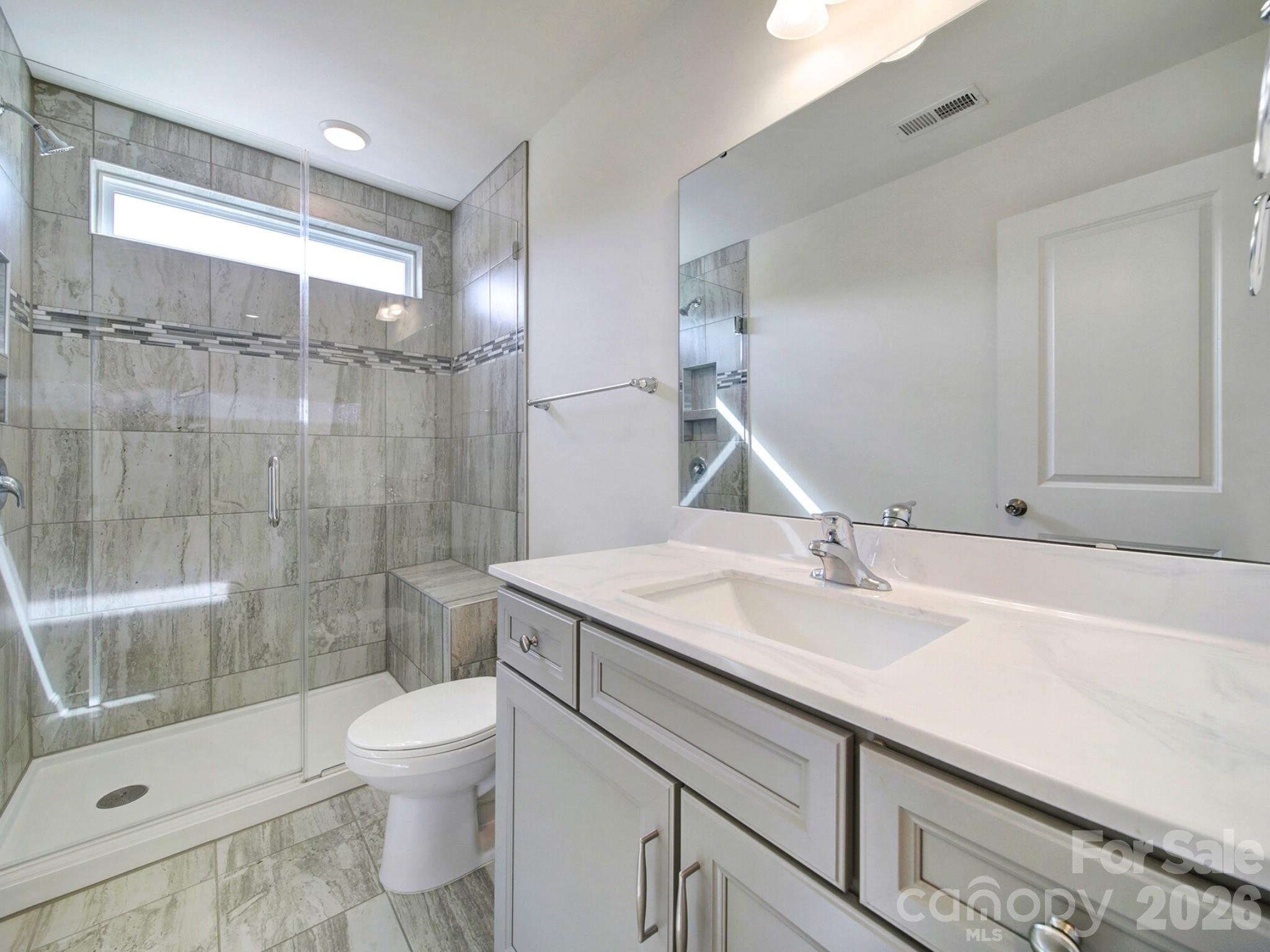 4003 Rothwood Lane Harrisburg, NC 28075 - Photo 26 of 30 a bathroom with a sink toilet and shower