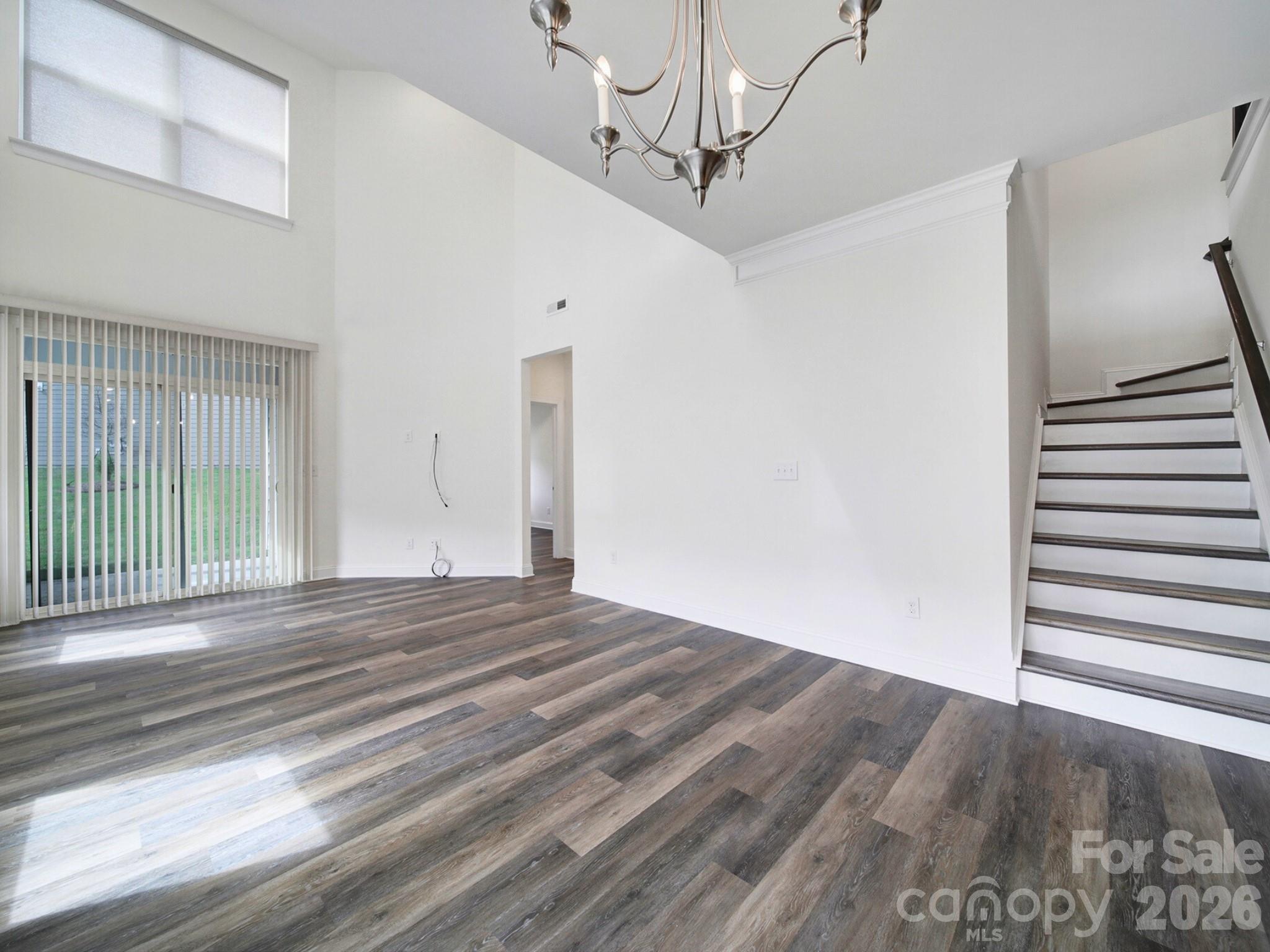 4003 Rothwood Lane Harrisburg, NC 28075 - Photo 9 of 30 a view of empty room with wooden floor and fan