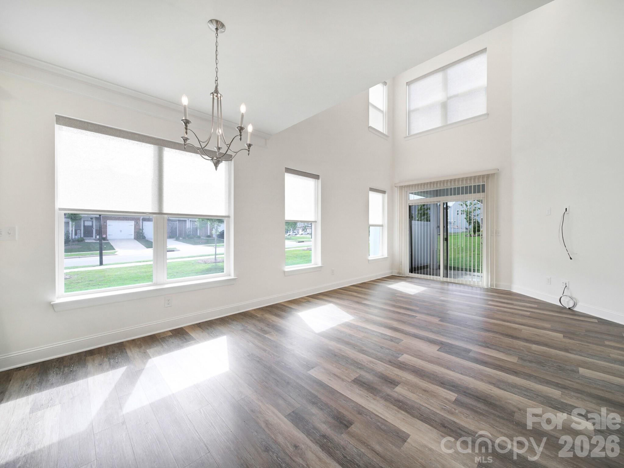 4003 Rothwood Lane Harrisburg, NC 28075 - Photo 10 of 30 a view of an empty room with wooden floor and a window