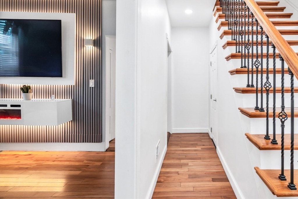 42 D Street Lowell, MA 01851 - Photo 8 of 27 a view of a hallway with wooden floor and staircase