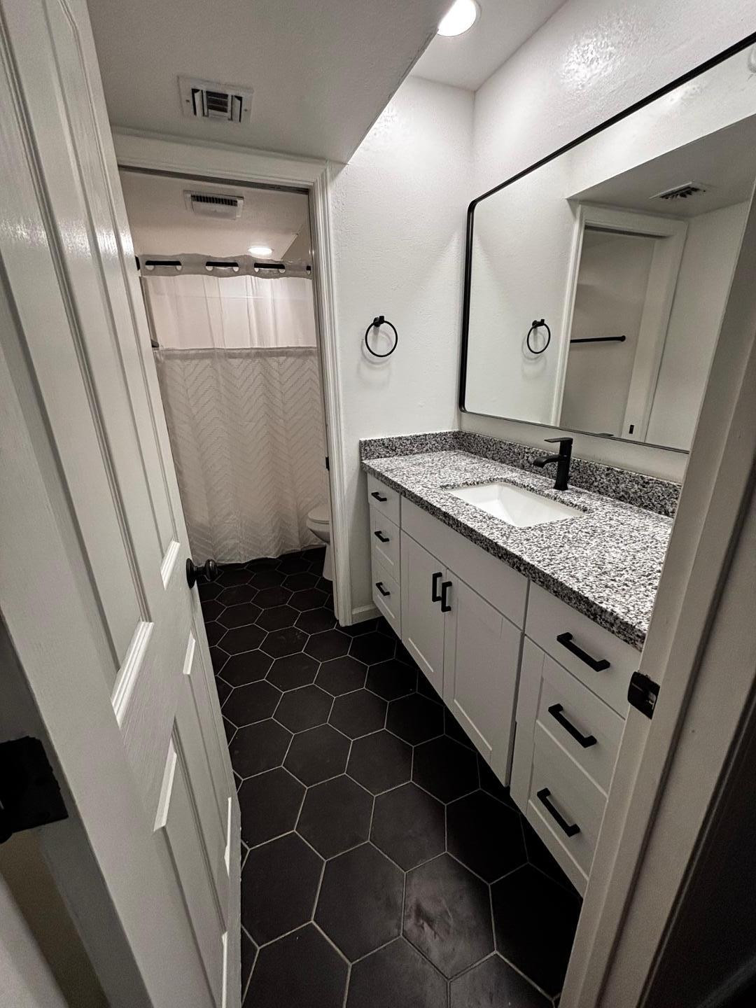 3030 North Hayden Road, Unit 16 Scottsdale, AZ 85251 - Photo 11 of 30 a bathroom with a granite countertop sink and a mirror
