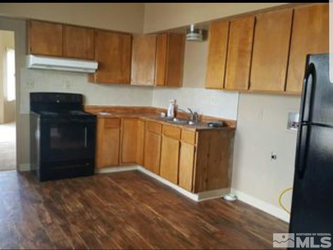 1285 East 9th Street Reno, NV 89512 - Photo 7 of 13 a kitchen with stainless steel appliances a refrigerator and a stove