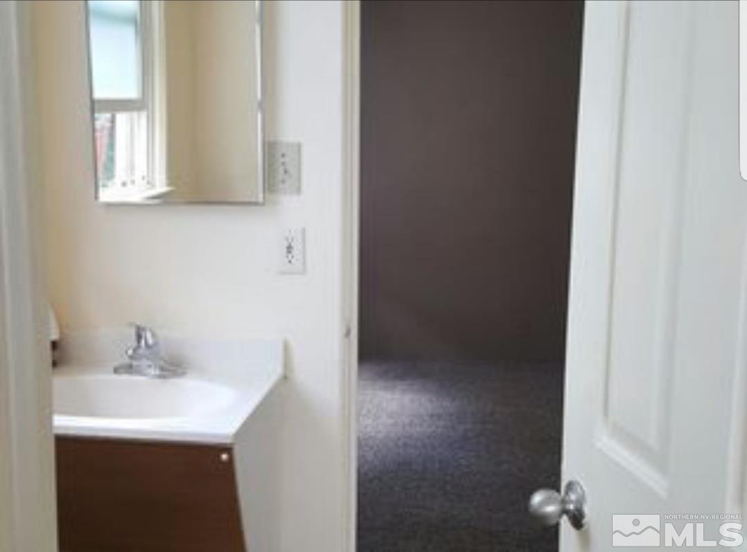1285 East 9th Street Reno, NV 89512 - Photo 8 of 13 a bathroom with a sink and a mirror