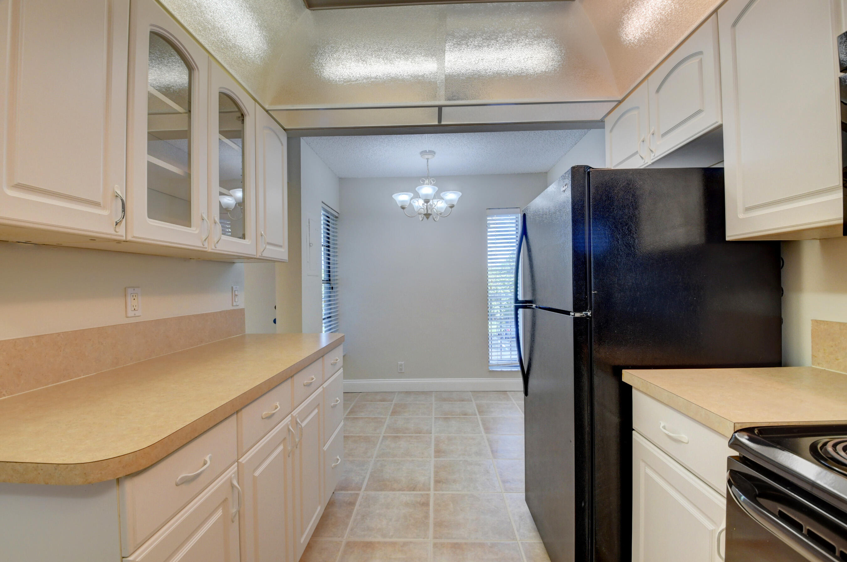 16 Royal Palm Way, Unit 202 Boca Raton, FL 33432 - Photo 12 of 54 a kitchen with a refrigerator and a cabinets