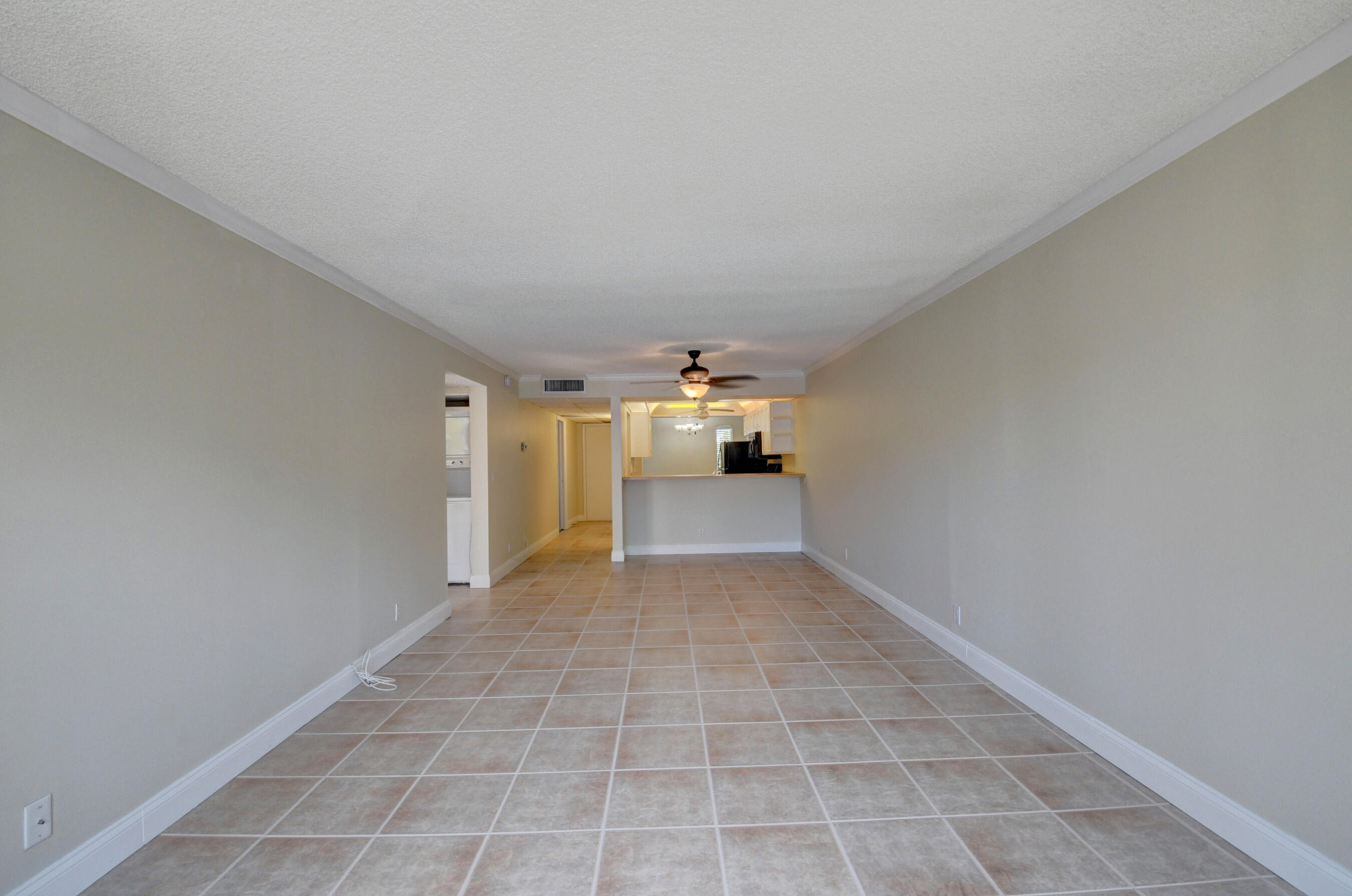 16 Royal Palm Way, Unit 202 Boca Raton, FL 33432 - Photo 18 of 54 a view of a big room with wooden floor and a window