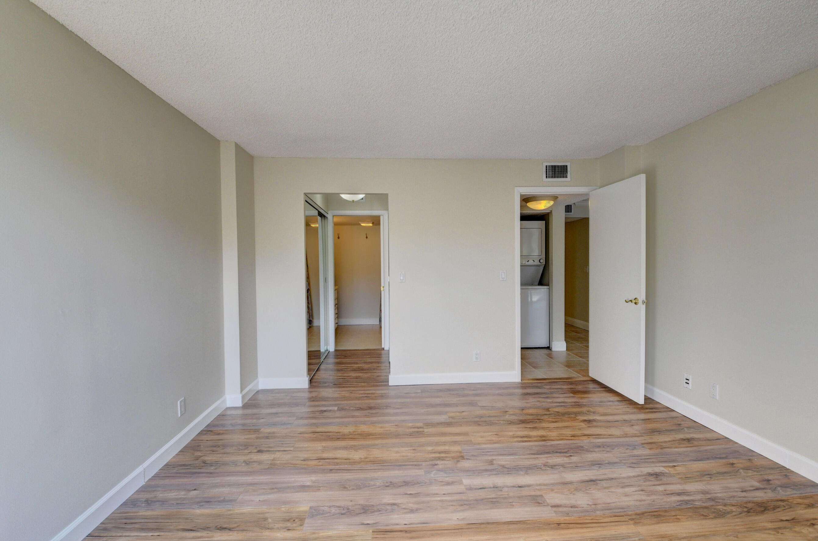 16 Royal Palm Way, Unit 202 Boca Raton, FL 33432 - Photo 24 of 54 a view of an empty room with wooden floor and closet