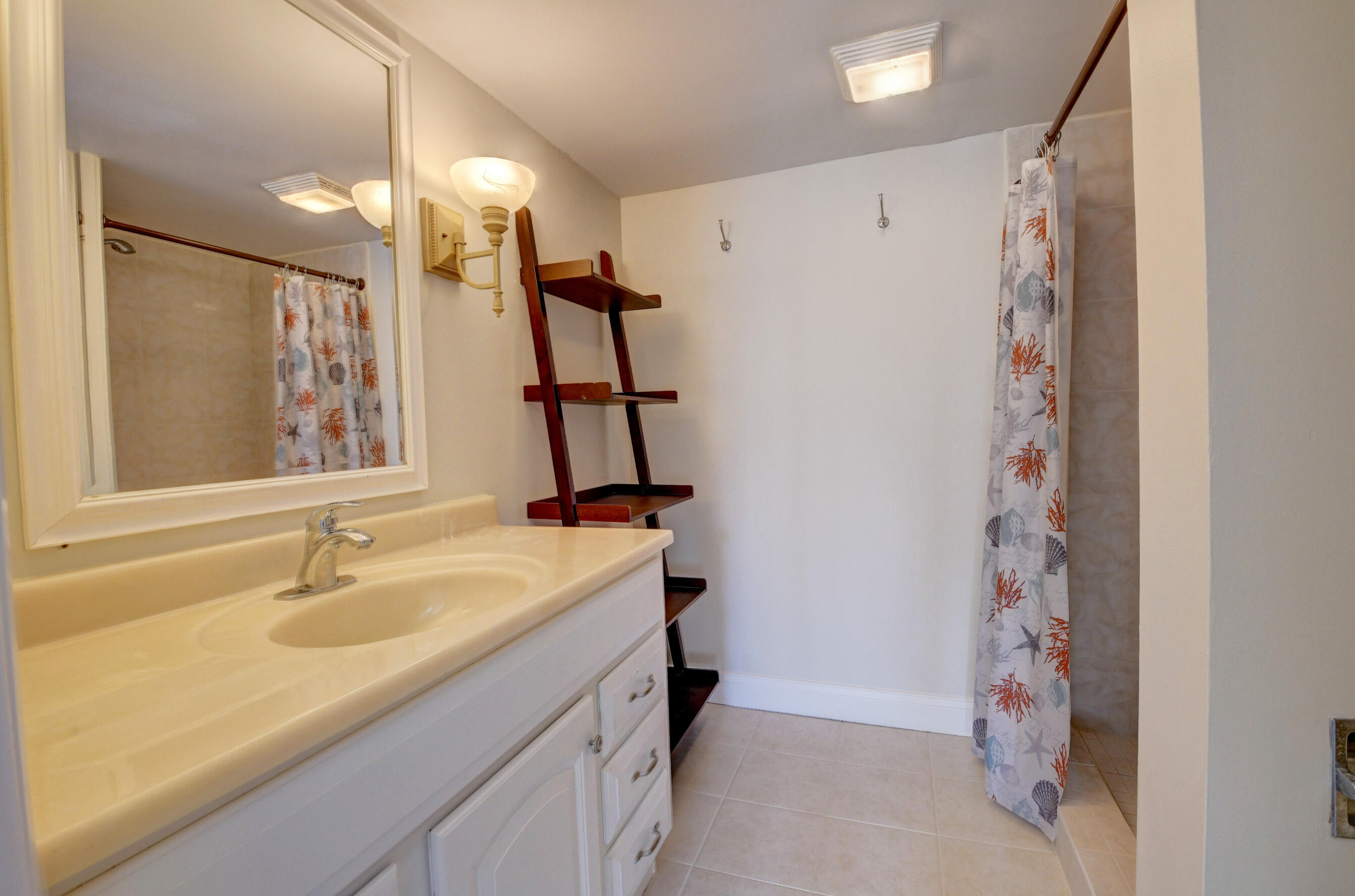 16 Royal Palm Way, Unit 202 Boca Raton, FL 33432 - Photo 26 of 54 a bathroom with a sink and a mirror