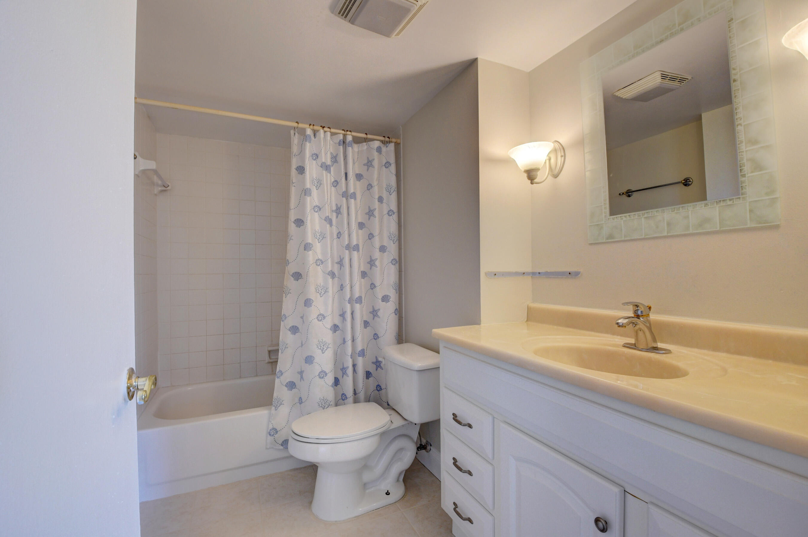 16 Royal Palm Way, Unit 202 Boca Raton, FL 33432 - Photo 32 of 54 a bathroom with a sink a toilet and shower