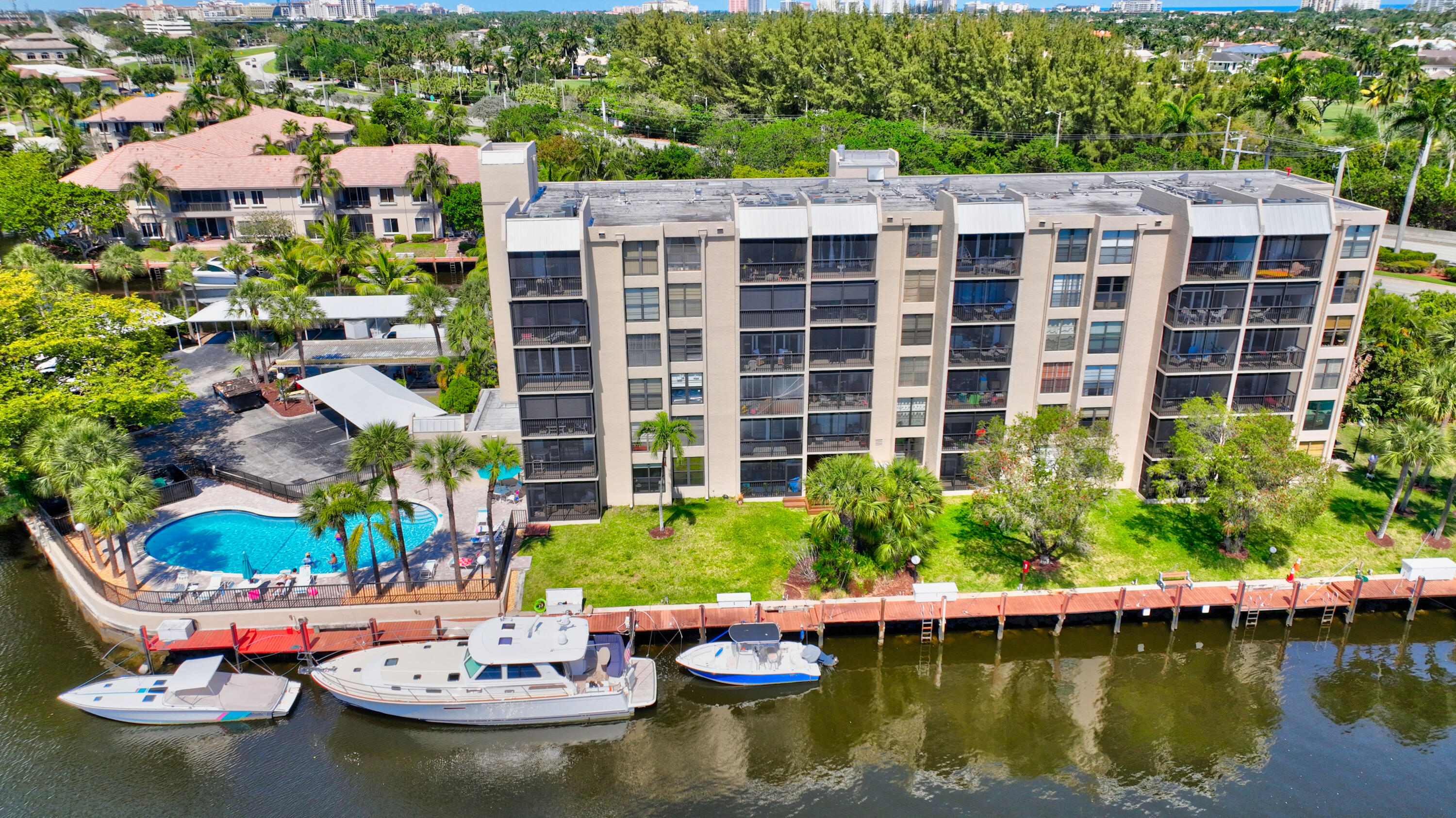 16 Royal Palm Way, Unit 202 Boca Raton, FL 33432 - Photo 50 of 54 a view of a swimming pool with a patio and plants