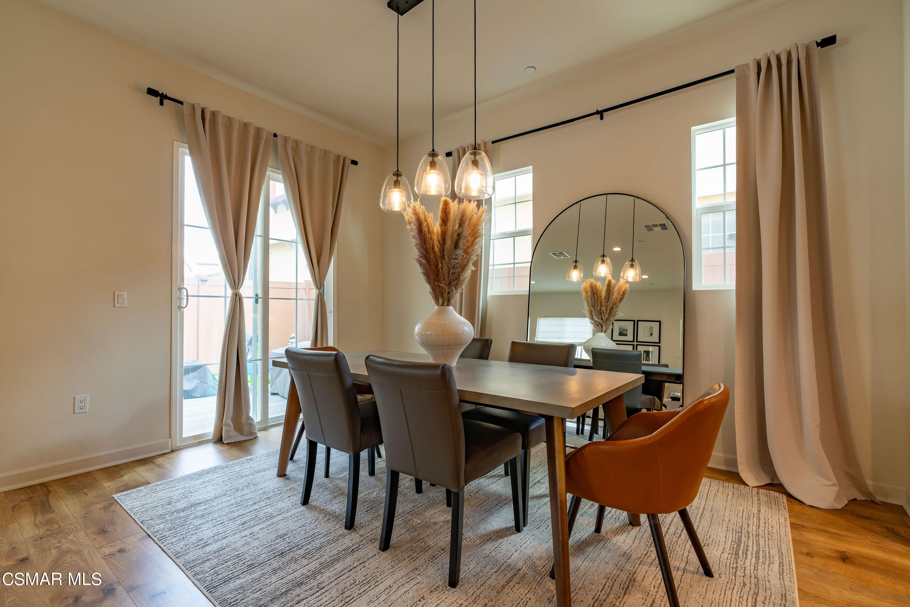 1614 Range Road Oxnard, CA 93036 - Photo 5 of 26 a dining room with furniture a chandelier and wooden floor